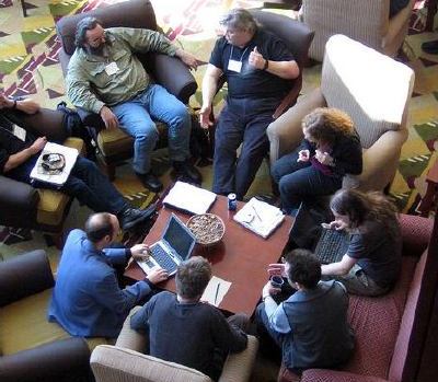 circle of attendees seated speaking