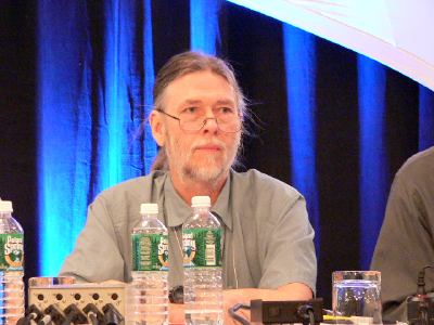 Jim Melton seated in panel