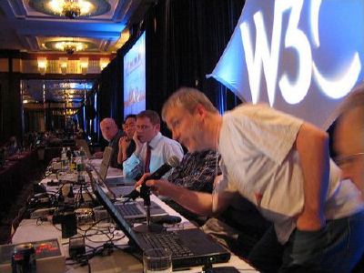 Steve Pepper speaking into the mic, the panel'