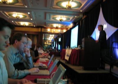 Steve Bratt on stage, plenary front row